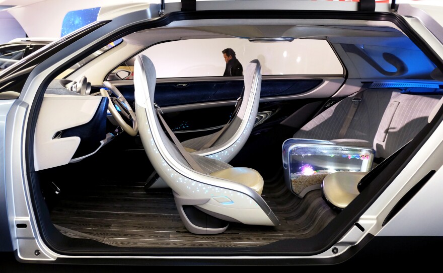 Chinese automaker GAC Group's WitStar concept autonomous electric car features a fish tank armrest in the back seat.