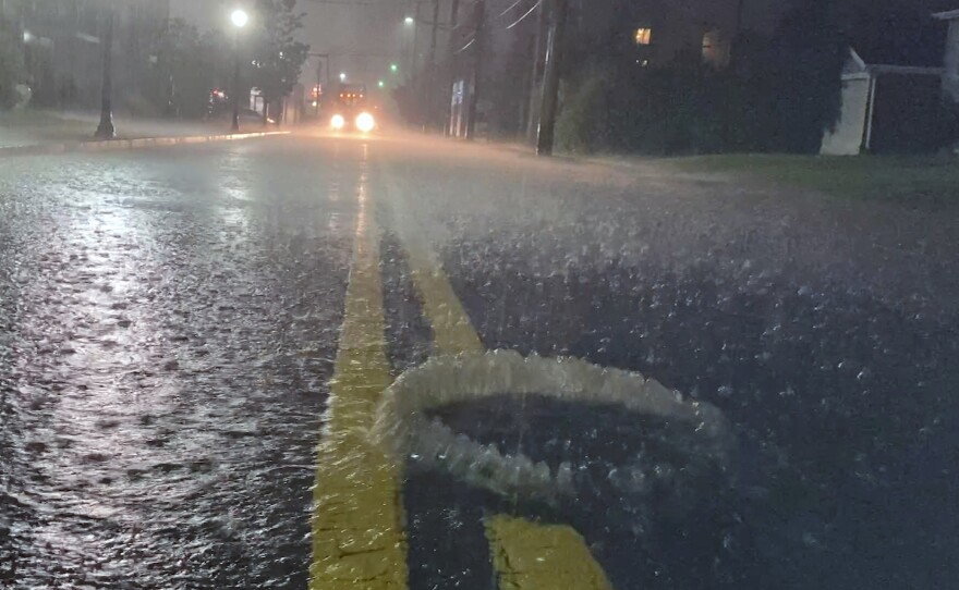 A utility hole cover bubbles open in a road flooded by the remnants of Hurricane Ida. Across the U.S., millions of miles of pipes and stormwater infrastructure stretch below city streets. Most are decades-old, designed for the storms of last century.