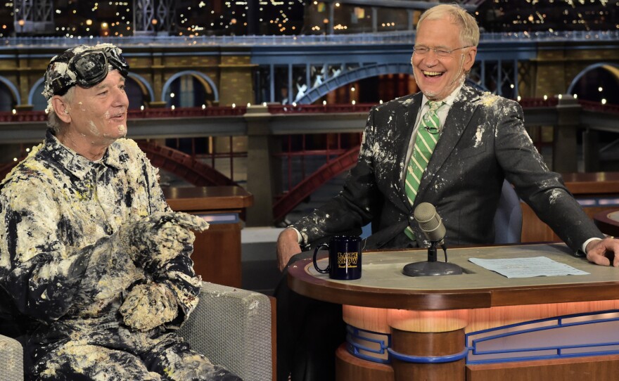 Bill Murray emerged from a cake to give David Letterman a good-bye embrace during Tuesday's taping of The Late Show. Letterman is ending his run as the show's host Wednesday.