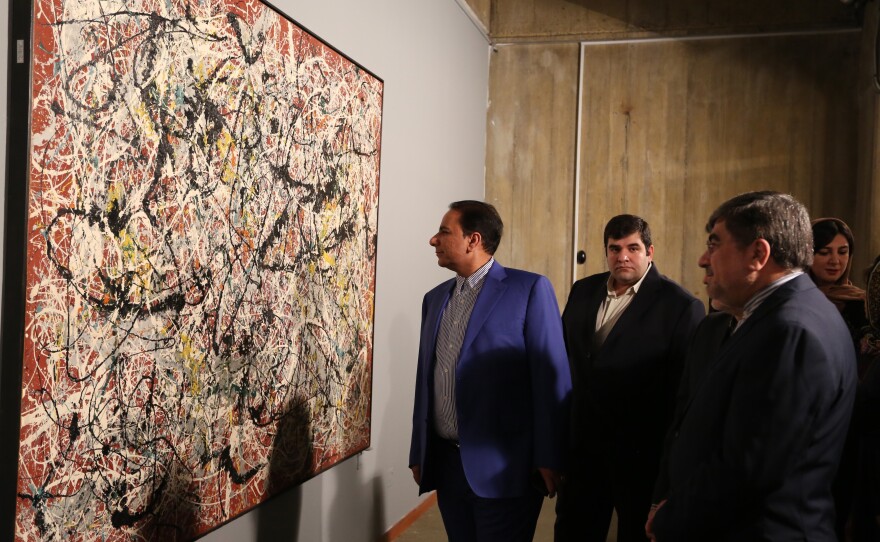 Iranian Culture Minister Ali Jannati (right) looks at Jackson Pollock's "Mural on Indian Red Ground" (1950) during the opening ceremony of an exhibition at Tehran's Museum of Contemporary Art on Nov. 20.
