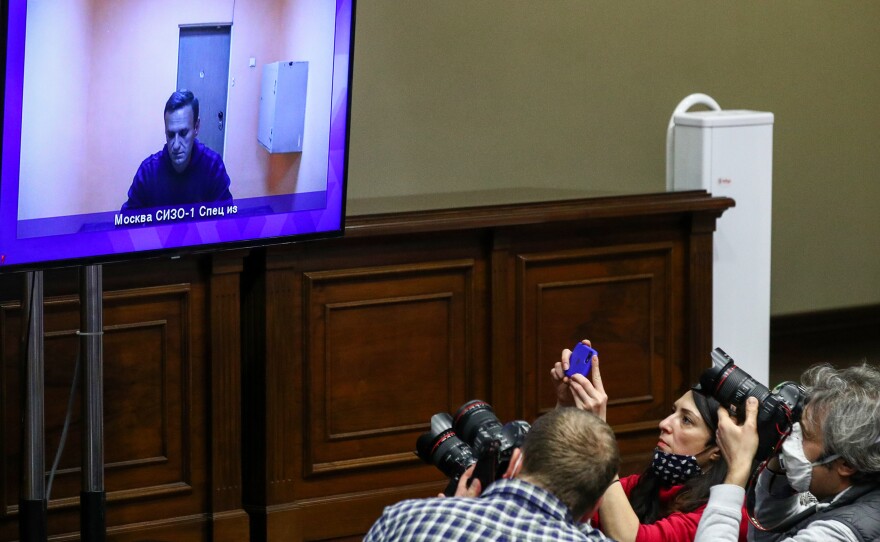Journalists watch Alexei Navalny appear on a video screen in a Moscow regional court. The court rejected Navalny's appeal of his 30-day detention.