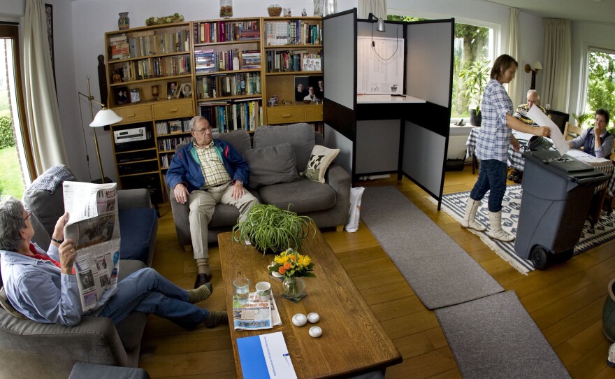 A woman casts her vote at a polling station in the living room of the Westhoff family's house in Marle, the eastern Netherlands, in 2010.