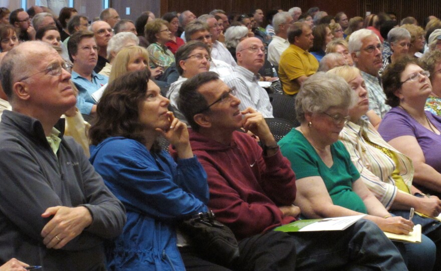 The audience concentrates on a presentation by Kansas Insurance Commissioner Sandy Praeger's office about the federal health care overhaul at the University of Kansas satellite campus in Overland Park, Kan., earlier this month.