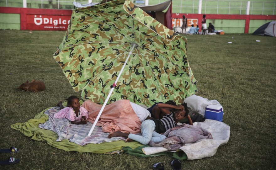 <strong>Sun., Aug. 15:</strong> People rest after spending the night at a soccer field following Saturday's earthquake in Les Cayes.