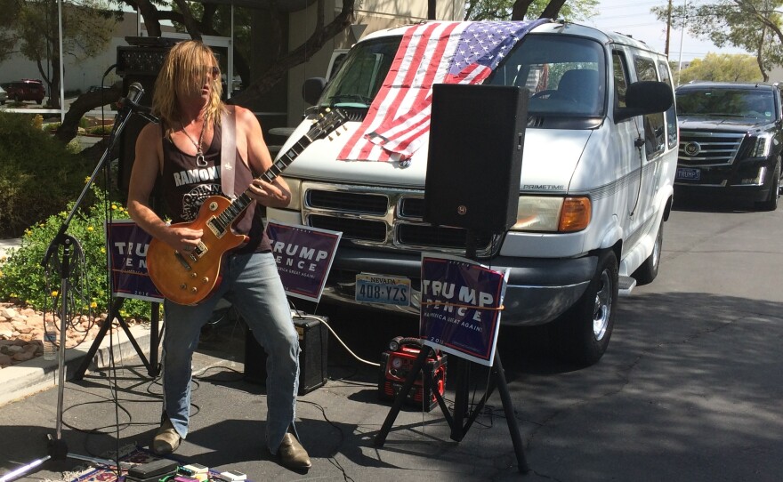 Steven Boz performs outside of a Trump campaign office. He says he loves Trump's "attitude."