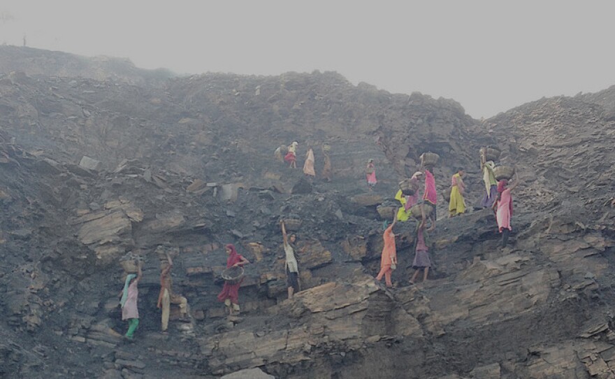 The dignified-looking procession is actually a line of coal thieves at a mine in Jharia, India, snatching chunks early in the morning before officials arrive.