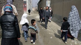 Aziz Royesh (center) in the streets near the Marefat School in Kabul.
