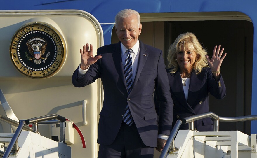President Joe Biden and First Lady Jill Biden wave as they arrive in England ahead of the G7 summit on Wednesday.