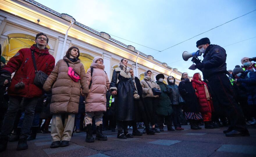 A police officer uses a loudspeaker to address people gathered in St. Petersburg to protest Russia's invasion of Ukraine on Feb. 24.