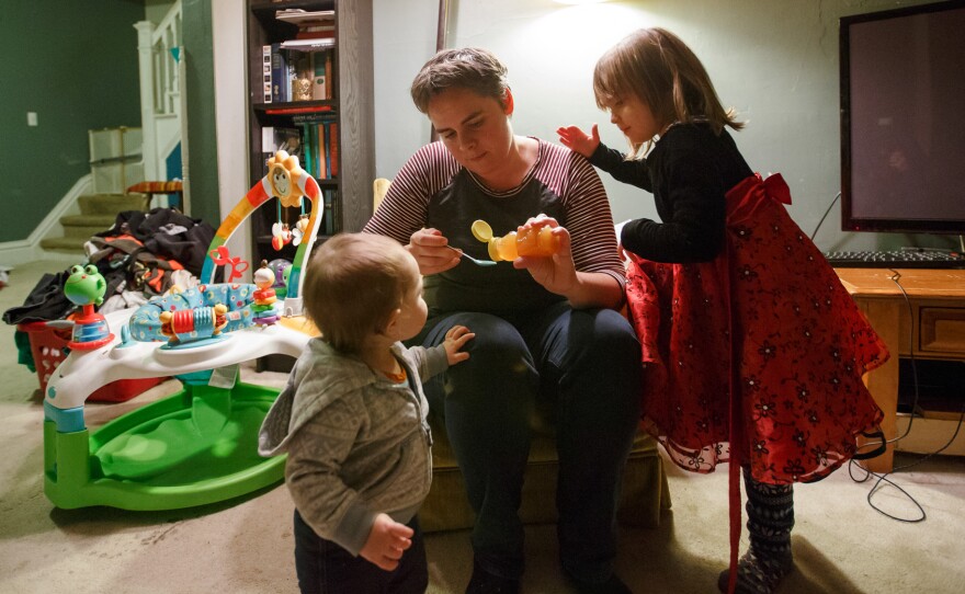 Four-year-old Violet (right) supervises as her mom Margaret Siebers pours a first-ever spoonful of honey for 1-year-old Frances to try. Siebers spent much of the end of her pregnancy with Frances confined to bed rest at her home in Milwaukee.