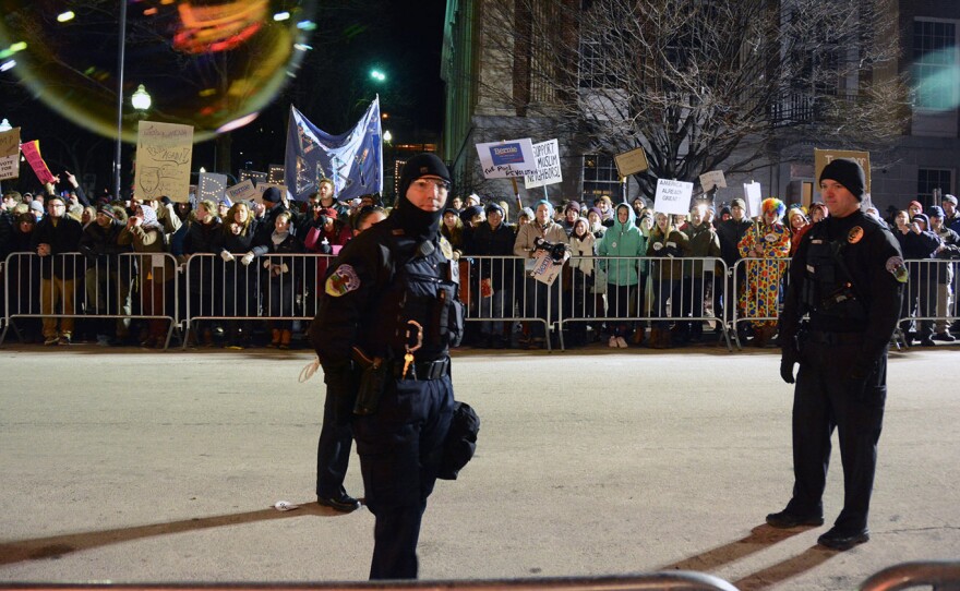 Police monitor protesters outside Thursday's Donald Trump campaign event in Burlington, Vt.