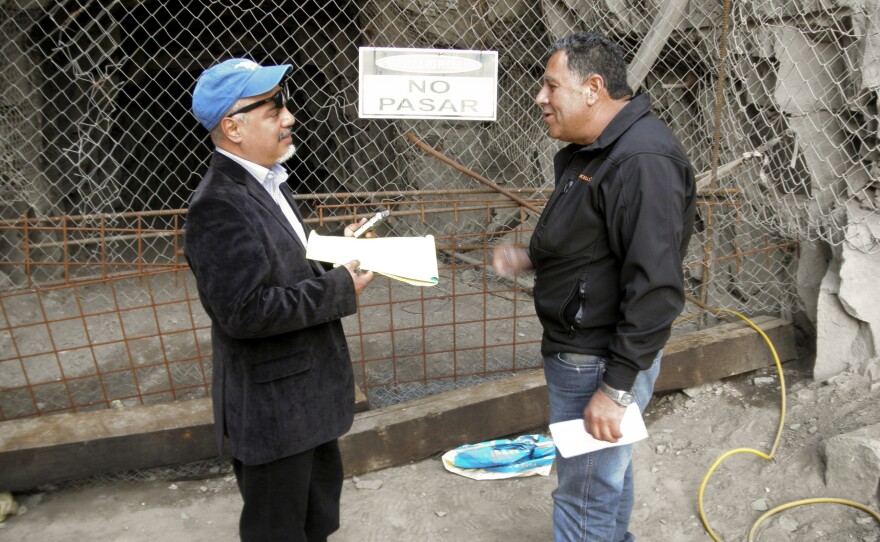 Hector Tobar (left) stands in front of a mine entrance with Luis Urzúa, the head of the shift of trapped miners, in 2011 at the San Jose Mine.