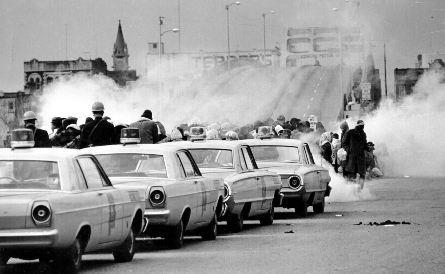 Tear gas fills the air as state troopers, ordered by Gov. George Wallace, break up a march at the Edmund Pettus Bridge in Selma, Ala., on March 7, 1965.