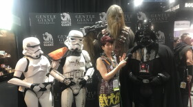 KPBS arts reporter Beth Accomando experiencing some Imperial entanglements at Comic-Con. From the 501st Legion: (L-R) Leslie Camerino (Stormtrooper), Dan Deaver (Sandtrooper), and Andy SalmonsenI (Darth Vader), and Chewbacca was a prop by Gentle Giant and therefore not much help in actively fighting evil that day. July 22, 2018