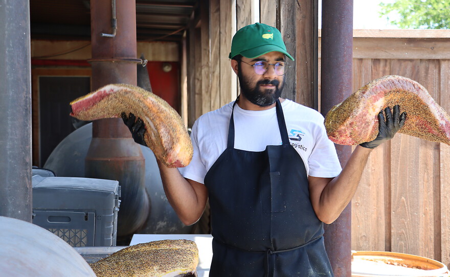 Zain Shafi prepares to put briskets in the smoker at Goldee's BBQ in Fort Worth, Texas.