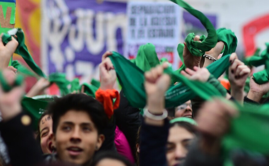 Activists wave green handkerchiefs in front of the National Congress Building while senators vote for the new abortion law on August 8, 2018 in Buenos Aires, Argentina.