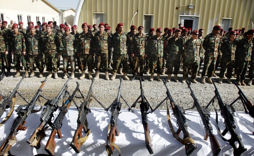 Members of the Afghan army attend an event showing weapons seized from militants during various operations in Uruzgan, Zabul and Kandahar, south of Kabul on April 6.