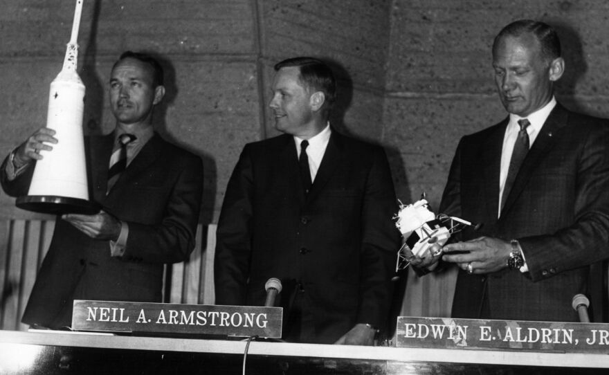 From left: Michael Collins, Neil Armstrong and Buzz Aldrin in Paris in 1969. Aldrin holds a lunar module model of similar size and shape to the gold one stolen Friday.