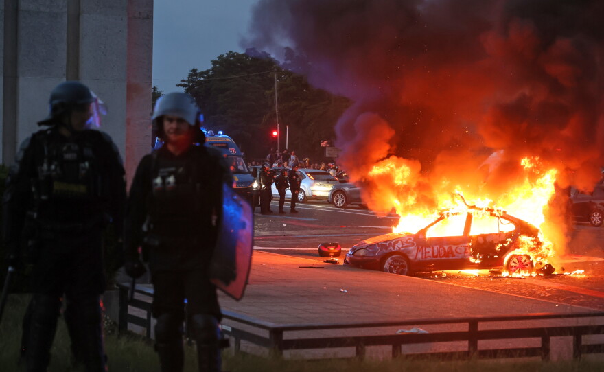 A car burns as PSG supporters celebrate in Paris, Saturday, May 30, 2026 after the Champions League final soccer match between Paris Saint-Germain and Arsenal that's being played in Budapest., PSG won the game.