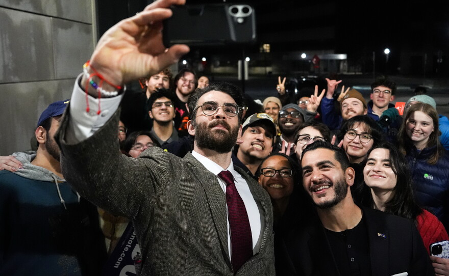 Streamer Hasan Piker, left, and Abdul El-Sayed, a progressive candidate in the Democratic primary for U.S. Senate in Michigan, center right, take a selfie with young fans following a campaign event on April 7, 2026, at the University of Michigan in Ann Arbor.