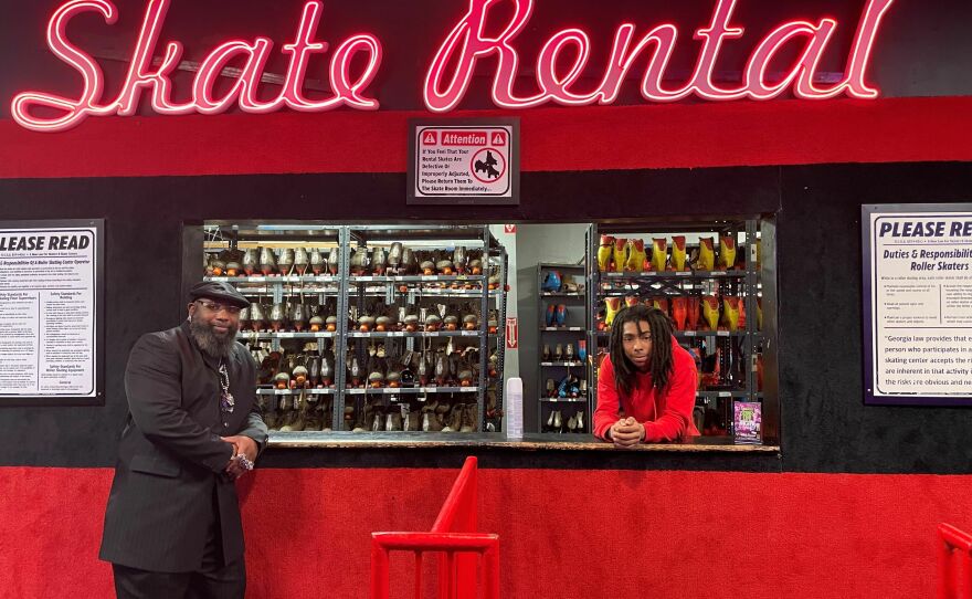 Marcus Allen, left, and an employee at Cascade Skating Rink in Atlanta pose by the Skate Rental counter. Allen last voted in 2008, when he cast a ballot for Barack Obama. Since then, he feels like politicians don't do enough for him to vote for them.