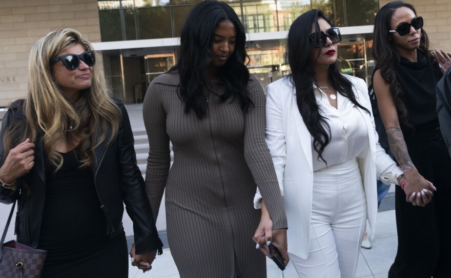 Vanessa Bryant, center, Kobe Bryant's widow, leaves a federal courthouse with her daughter Natalia and soccer player Sydney Leroux in Los Angeles, Aug. 24, 2022.