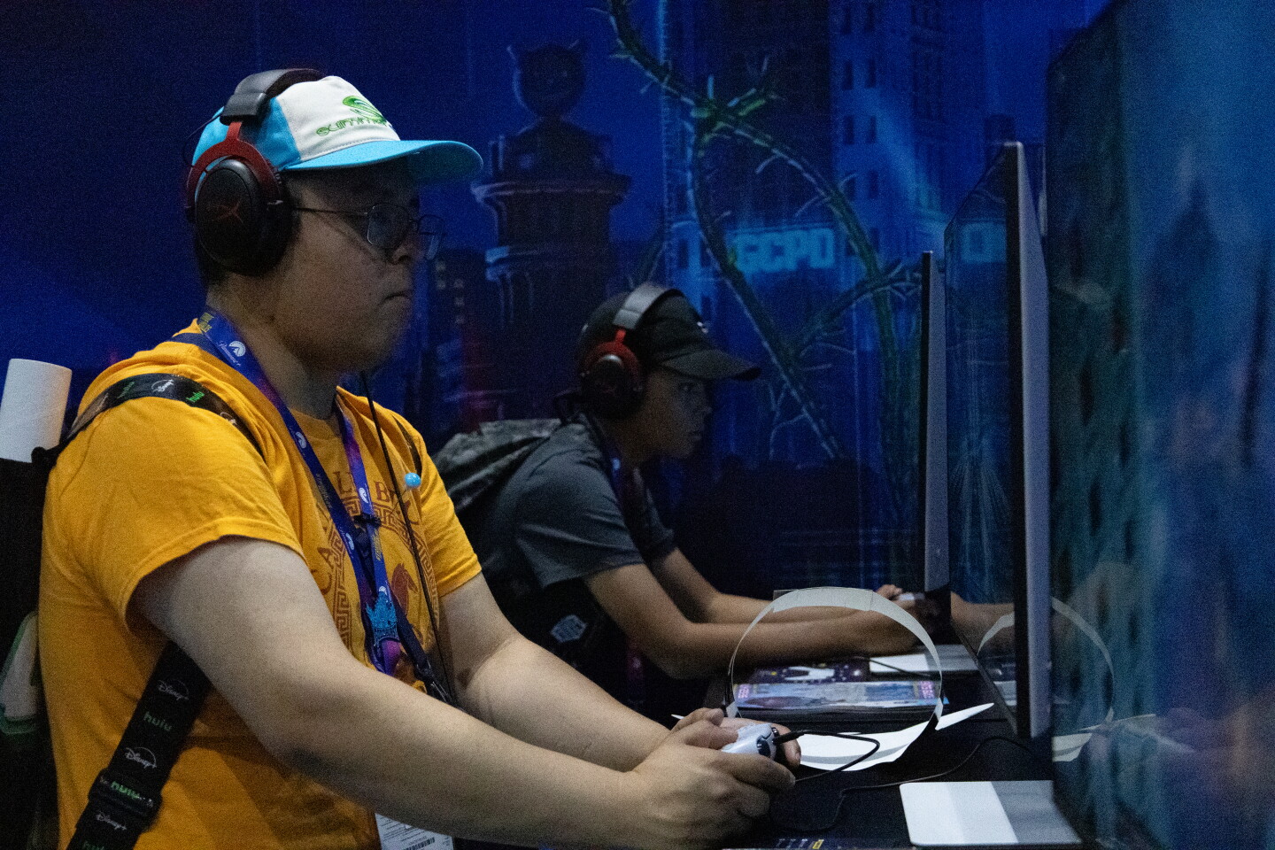 Attendees play a video game pop-up at Comic-Con, April 23, 2026.