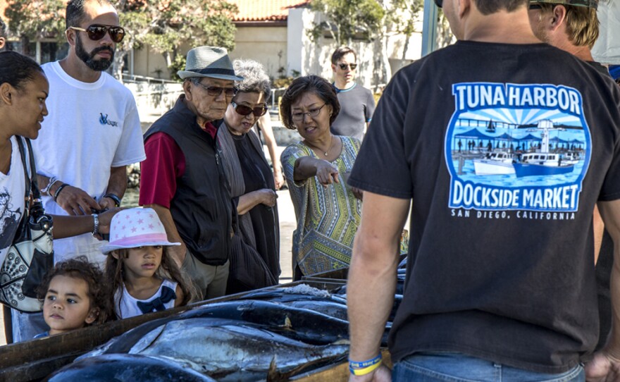 Customers survey the fresh fish at the Tuna Harbor Dockside Market on a Saturday morning in October 2016. Photo by Megan Wood, inewsource.