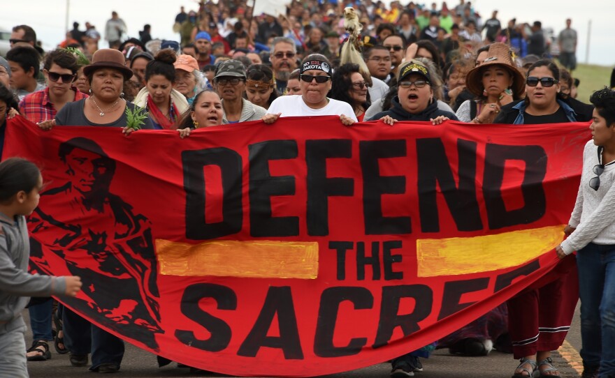Native Americans march to a sacred burial ground site that was disturbed by bulldozers building the Dakota Access Pipeline in North Dakota, where hundreds of people have gathered to join the Standing Rock Sioux Tribe's protest.