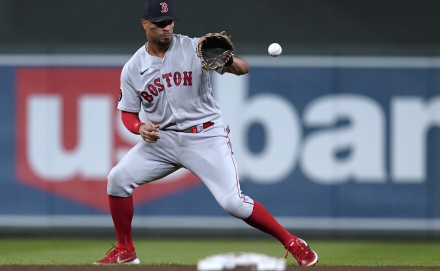 File photo of Boston Red Sox's Xander Bogaerts fielding the ball hit by Minnesota Twins' Luis Arraez during the fifth inning of a baseball game Aug. 31, 2022, in Minneapolis.