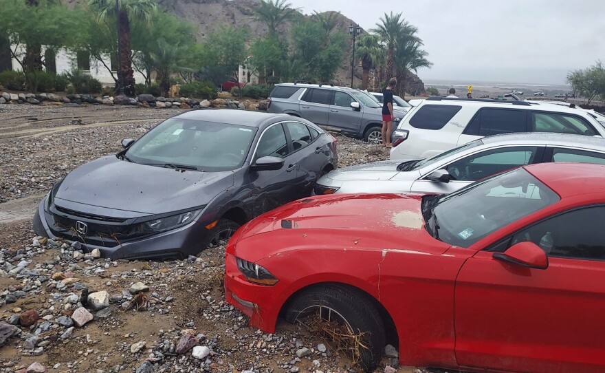 In this photo provided by the National Park Service, cars are stuck in mud and debris from flash flooding at The Inn at Death Valley in Death Valley National Park, Calif., Friday, Aug. 5, 2022. Heavy rainfall triggered flash flooding that closed several roads in Death Valley National Park on Friday near the California-Nevada line. The National Weather Service reported that all park roads had been closed after 1 to 2 inches of rain fell in a short amount of time.