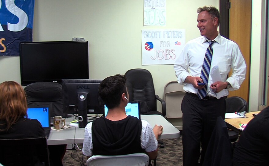 Rep. Scott Peters talks with volunteers in his campaign office on September 26, 2014.