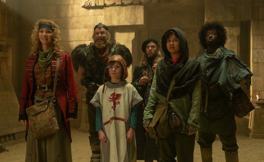 Kevin (Kal-El Tuck, center) travels through holes in time with a ragtag band of thieves led by Penelope (Lisa Kudrow). (2024)