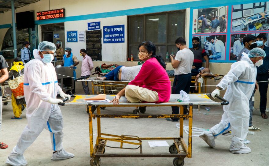 Health workers transport a COVID-19 patient in a hospital complex last week in New Delhi.