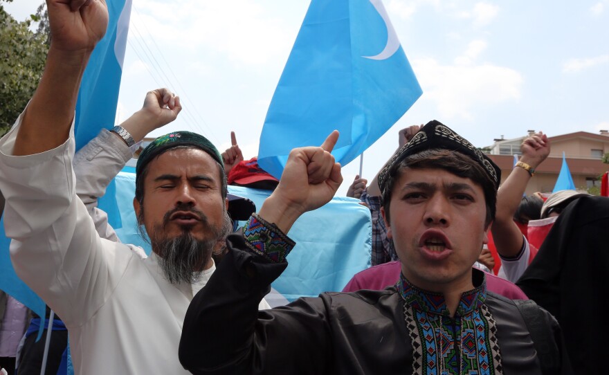 A group of Uighur protesters demonstrate outside the Thai embassy in Ankara, Turkey, on Thursday to protest Thailand's deportation of 100 Uighur refugees back to China.