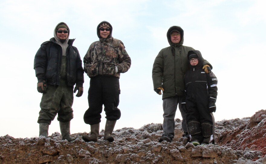Noah "Robert" Waska (left), Dalen Ayuluk, Andrew John and Jason John stand above the rock quarry at Mertarvik, the site where Newtok residents hope to relocate their entire village.
