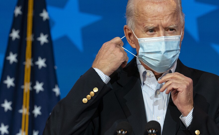 President-Elect Joe Biden removes his face mask to speak at The Queen theater in Wilmington, Del., on Thursday. When Biden takes office he'll be dealing with a virus that is rampaging through theU.S.×