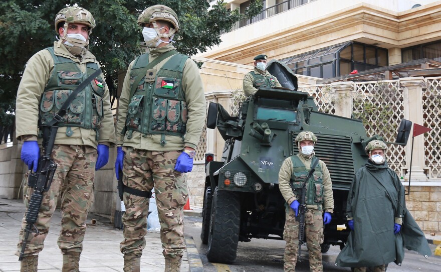 Jordanian soldiers keep watch in the capital Amman as Jordan takes measures to fight the spread of the coronavirus.