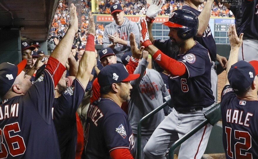 The Washington Nationals congratulate Anthony Rendon after his two-run home run during the seventh inning of Game 6 of the World Series against the Houston Astros on Tuesday.