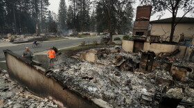 Chris Mutton, left, whose house burned in a wildfire speaks with Shane Maggart on Aug. 2, 2026, in Spokane, Wash.