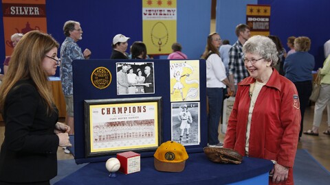 Leila Dunbar (left) appraises a Girls Pro Baseball League collection, ca. 1950, in Eugene, Ore. 