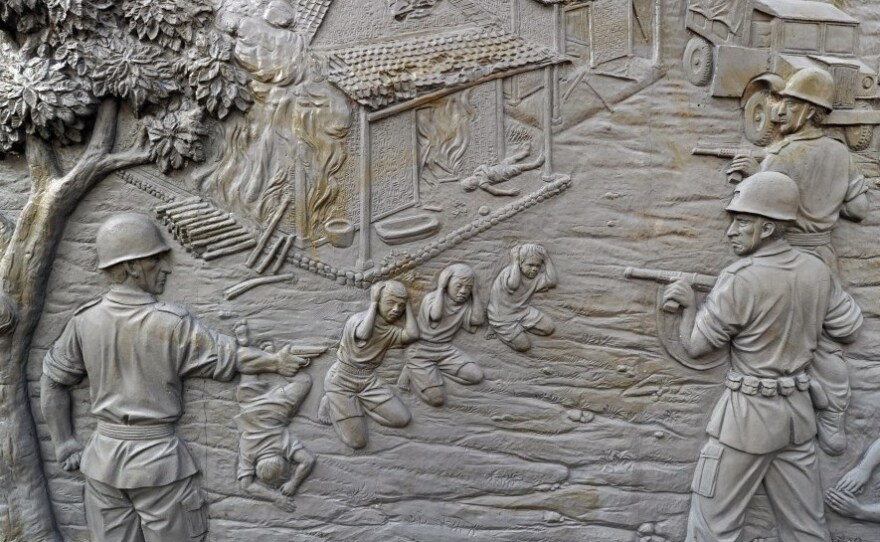 A mural at the Rawagede monument of independence (shown here on Sept. 15) depicts the 1947 massacre by Dutch military troops. The Dutch government long ago admitted to the killings and donated money to the village — but refused to link the funds to the massacre.