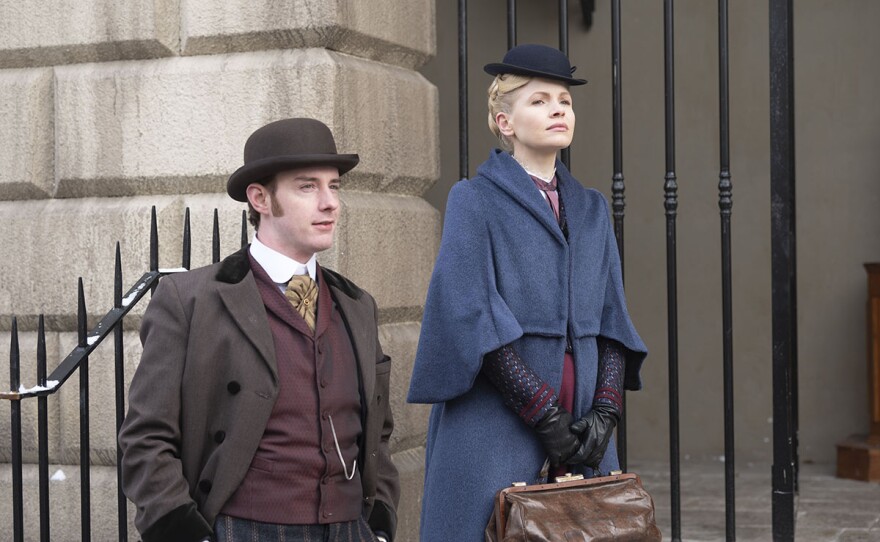 Evan McCabe as Detective Fitzroy and Kate Phillips as Eliza Scarlet