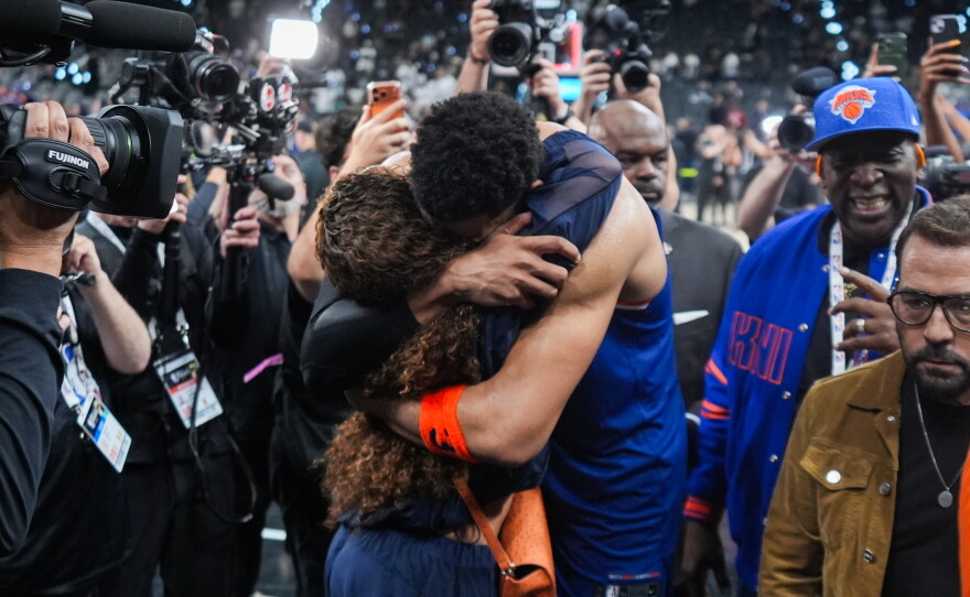 New York Knicks center Karl-Anthony Towns is embraces as he leaves the court after Game 2 of the NBA Finals basketball series against the San Antonio Spurs, Friday, June 5, 2026, in San Antonio.