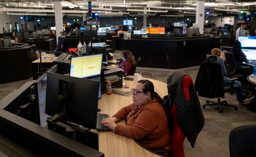 Silvia Morales, a bilingual emergency communications technician, works between calls at Denver 911.