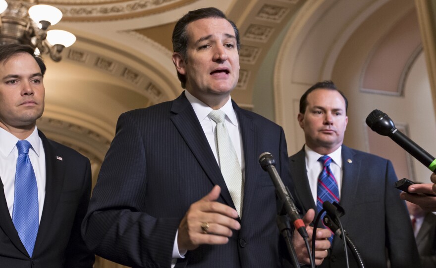 Sen. Ted Cruz, R-Texas, center, Sen. Marco Rubio, R-Fla., left, and Sen. Mike Lee, R-Utah, right, express frustration Friday after the Senate passed a bill to fund the government, but stripped it of the defund Obamacare language as crafted by House Republicans.