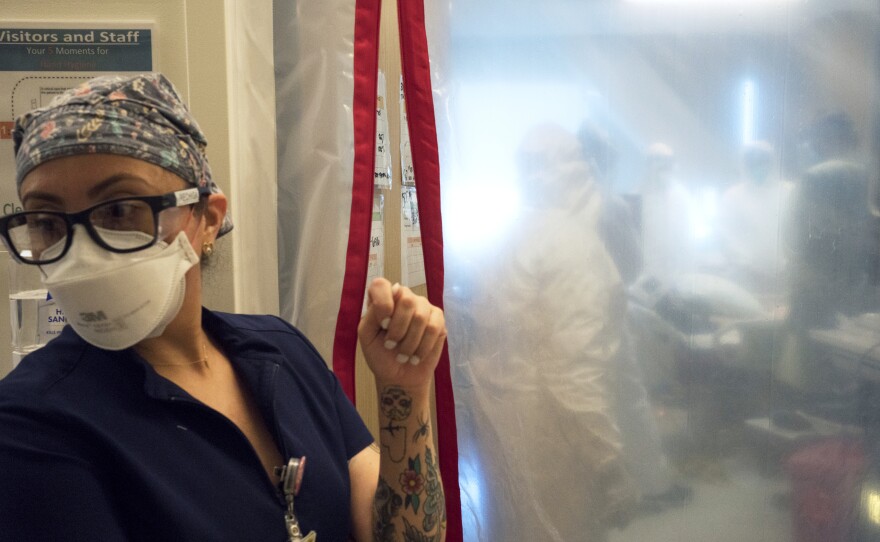 Maria Arechiga, an ICU charge nurse, monitors the progress of two COVID-19 patients in the intensive care unit of Martin Luther King Jr. Community Hospital in Los Angeles.