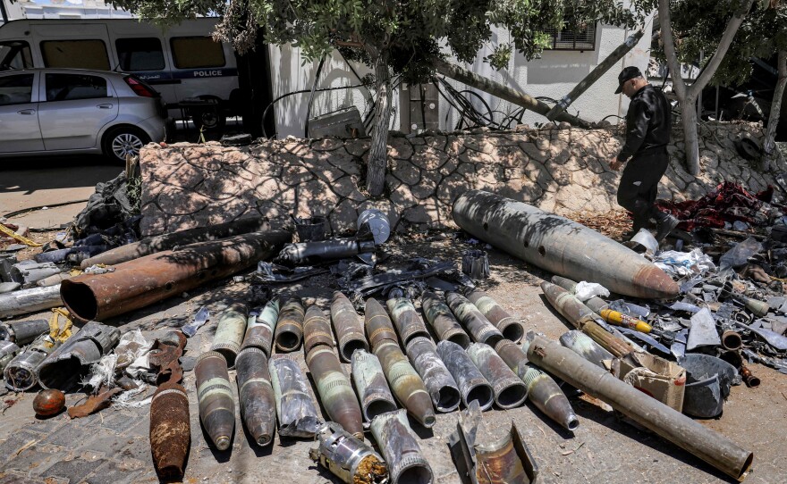 Explosives experts of Hamas lay out unexploded projectiles from the aftermath of the May 2021 conflict with Israel, at a local police precinct in Gaza City on June 5, 2021.