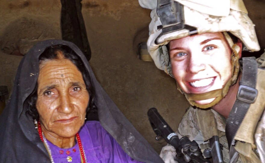 In this July 2012 photo, Cpl. Katherine Keleher (right) poses with a woman she met while on patrol in Sangin, Afghanistan. This photo appeared last fall on "Just the Tip, of the Spear," where members of the Facebook page posted comments ridiculing the former Marine. The group is one of several unofficial Marine Facebook pages that have been accused of denigrating female service members.