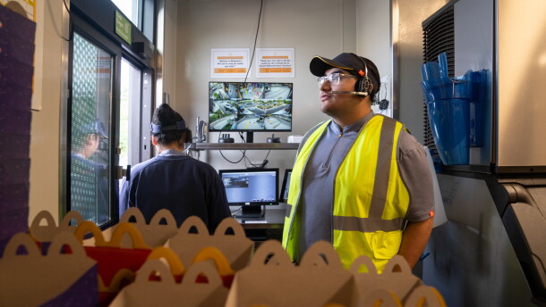 Ebert Velasquez Ramos (right) works at the drive-through at a McDonald's in Morningside, Md. He doesn't have a car so he sometimes turns to Escalate, a startup that provides Uber vouchers for workers who need last-minute rides among other support.